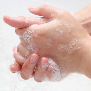 Hands with soap being washed